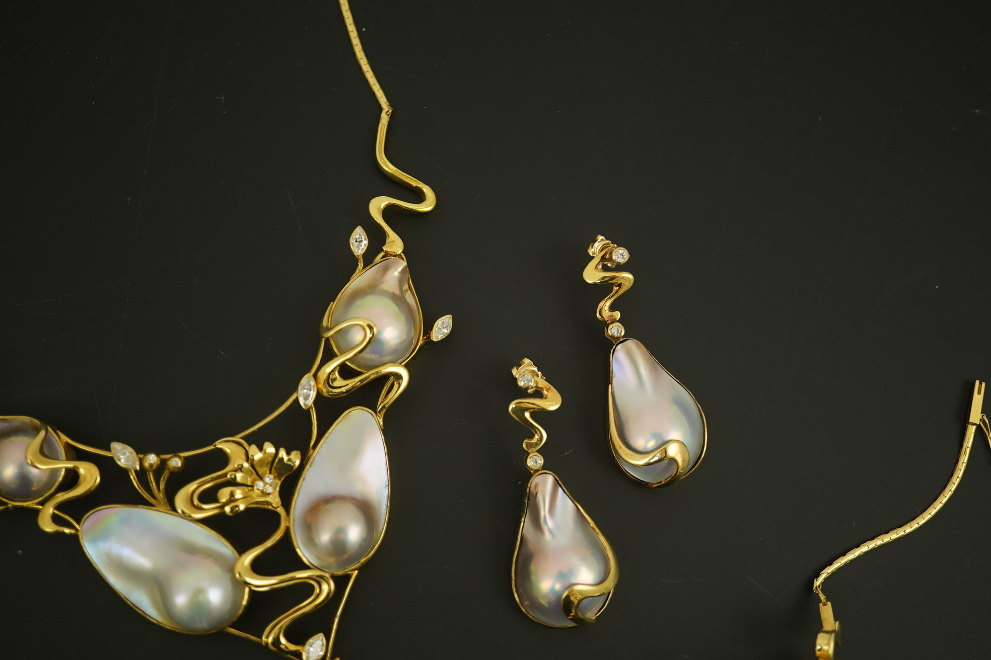 A modern suite of 18k gold, baroque pear, round and marquise diamond set jewellery